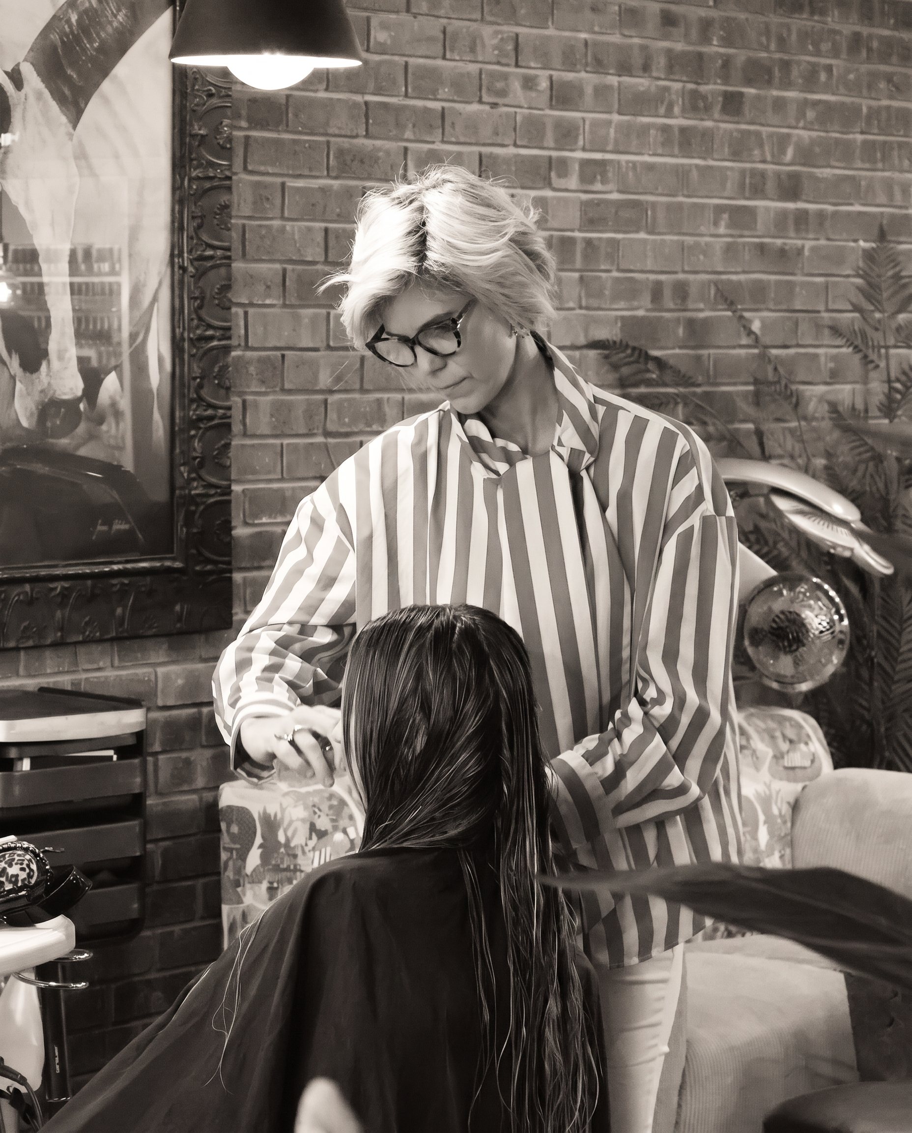 Kate styling a client's hair at Kate Style
