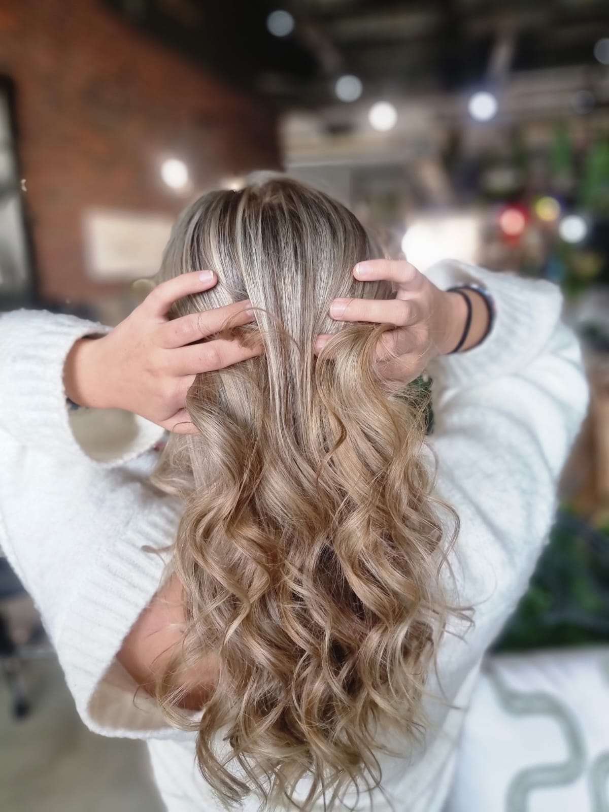 Blonde dimensional colour being styled by Kate